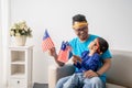 Father and son holding malaysian flag together while watching soccer match Royalty Free Stock Photo