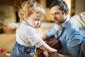 Father and son at home playing guitar together. Royalty Free Stock Photo