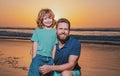 Father and son hugging on beach sunset. Happy family having fun on the sea. Royalty Free Stock Photo