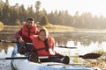 Father and son kayaking on rural lake, close up