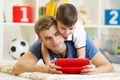 Father and son kid play with tablet computer Royalty Free Stock Photo