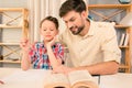 Father and son laughing while reading book at home Royalty Free Stock Photo