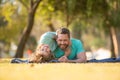 Father and son laying on grass in nature park. People having fun outdoors. Concept of happy vacation and friendly family Royalty Free Stock Photo