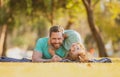 Father and son laying on grass in nature park. People having fun outdoors. Concept of happy vacation and friendly family Royalty Free Stock Photo