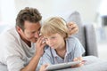 Father and son listening to music with headphones Royalty Free Stock Photo