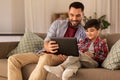 Father and son listening to music on tablet pc Royalty Free Stock Photo