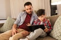 Father and son listening to music on tablet pc Royalty Free Stock Photo