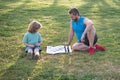 Father and son, little boy playing chess spending time together outdoor in summer park. Royalty Free Stock Photo