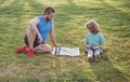 Father and son, little boy playing chess spending time together outdoor in summer park. Royalty Free Stock Photo