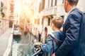 Father and son look together on venecian gondolas Royalty Free Stock Photo