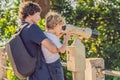 Father and son are looking at Coin-operated binoculars at the sea Royalty Free Stock Photo