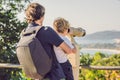 Father and son are looking at Coin-operated binoculars at the sea Royalty Free Stock Photo