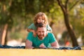 Father and son lying on grass. People having fun outdoors. Concept of happy vacation and friendly family. Royalty Free Stock Photo