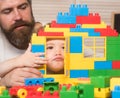 Father and son make grimaces looking through door of construction. Royalty Free Stock Photo