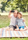 Father and son make a self photo on picknik Royalty Free Stock Photo