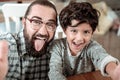 Father and son making funny faces while making photo together Royalty Free Stock Photo