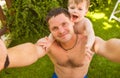 Father with son making selfie on the grass Royalty Free Stock Photo