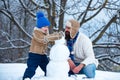 Father and son making snowman in the snow. Handmade funny snowman. Christmas holidays and winter new year with father Royalty Free Stock Photo