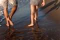 Father and son, man & boy child, running and having fun in the sand and waves Royalty Free Stock Photo