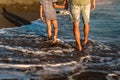 Father and son, man & boy child, running and having fun in the sand and waves Royalty Free Stock Photo