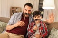 Father and son with mustaches having fun