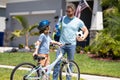 father and son navigate the path together. special bonding moment. Father and son enjoying a ride together. Supportive