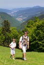 Father with son and newborn daughter in a baby carrier hiking in the mountains Royalty Free Stock Photo