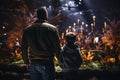 Father and son observing fish in large aquarium with stingrays and sharks swimming