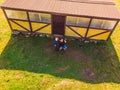 Father and son operating the drone by remote control. Young man with little boy flying drone, enjoying summer vacation