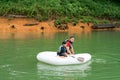 Father and son paddling on an inflatable boat at the Lake Kenyir, Malaysia Royalty Free Stock Photo