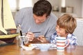 Father and son painting model ship