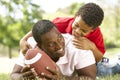 Father And Son In Park With American Football Royalty Free Stock Photo