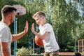 Father and son play basketball together at the basketball court. father spends time with the child, sporty lifestyle, training,