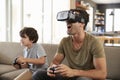 Father And Son Play Computer Game Using Virtual Reality Headset Royalty Free Stock Photo