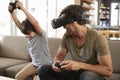 Father And Son Play Computer Game Using Virtual Reality Headset Royalty Free Stock Photo