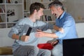 Father and son play fighting over remote control Royalty Free Stock Photo