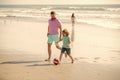 father and son play football on beach. daddy with kid boy on hot summer day. Royalty Free Stock Photo