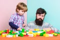 Father and son play game. small boy with dad playing together. love. child development. happy family leisure. building Royalty Free Stock Photo