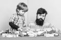 Father and son play game. small boy with dad playing together. love. child development. happy family leisure. building Royalty Free Stock Photo