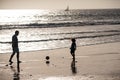 Father and son play soccer or football on the beach. Family travel, vacation, father's day concept. Dad and child Royalty Free Stock Photo