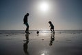 Father and son play soccer or football on the beach on summer family holidays. Daddy with kid boy playing on a summer Royalty Free Stock Photo