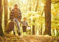 Father and son playing in the autumn forest. Father and son walking together in the park, fall day. Man with beard, dad Royalty Free Stock Photo