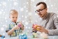 Father and son playing with ball clay at home Royalty Free Stock Photo
