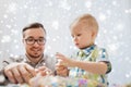 Father and son playing with ball clay at home Royalty Free Stock Photo