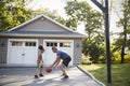 Father And Son Playing Basketball On Driveway At Home Royalty Free Stock Photo