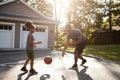 Father And Son Playing Basketball On Driveway At Home Royalty Free Stock Photo