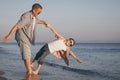 Father and son playing on the beach at the day time