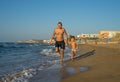 Father and Son Playing on the Beach, Having Quality Family Time Together. Greece. Royalty Free Stock Photo