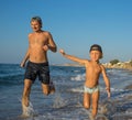 Father and Son Playing on the Beach, Having Quality Family Time Together. Greece. Royalty Free Stock Photo