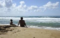 Father and son playing on the beach at the sunset time. Concept of friendly family